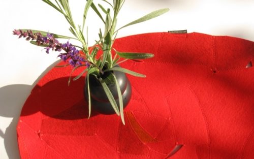 Smart bright red oval wool felt table hot pad for sale.