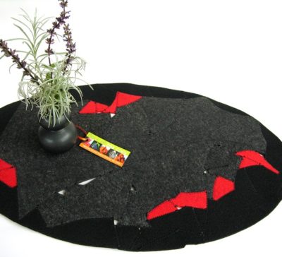 Eco design table topper trivet in upcycled wool felt offcuts in charcoal black and red