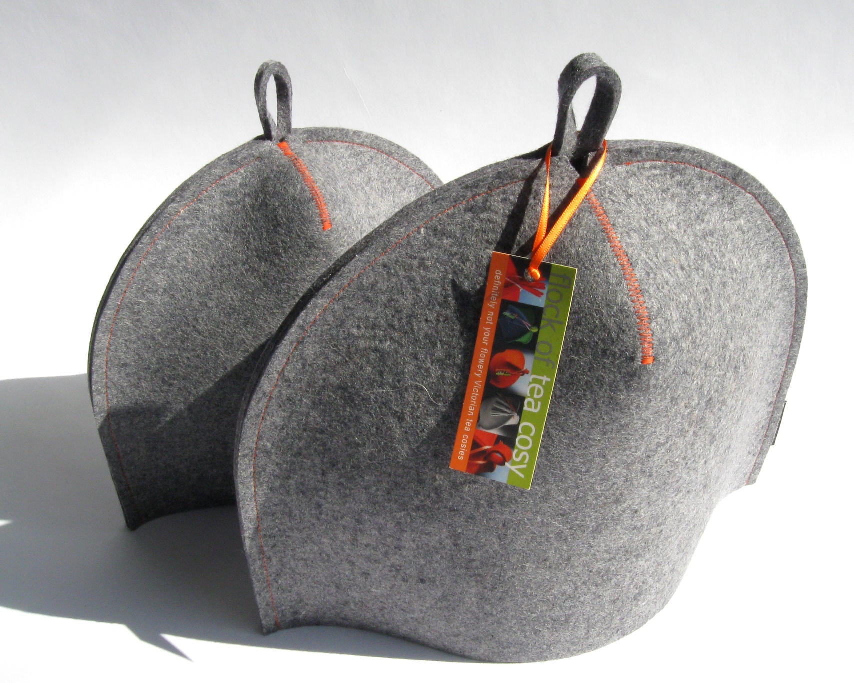 A pair of Classic "Baseball" tea cozies in industrial wool felt by Flock of Tea Cosy