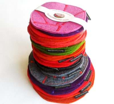 Stack of colourful wool felt coasters, eco concious and stylish.