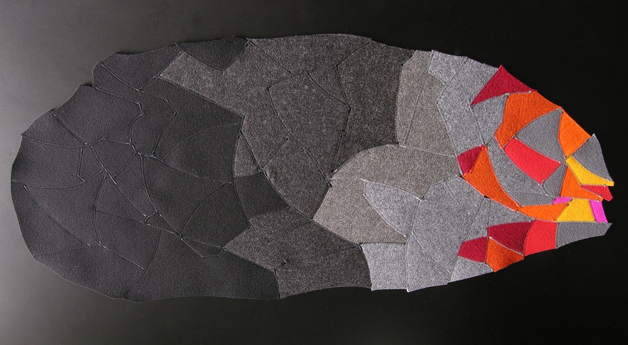 Table topper in wool felt black greys and fiery orange red and yello like a comet SOLD