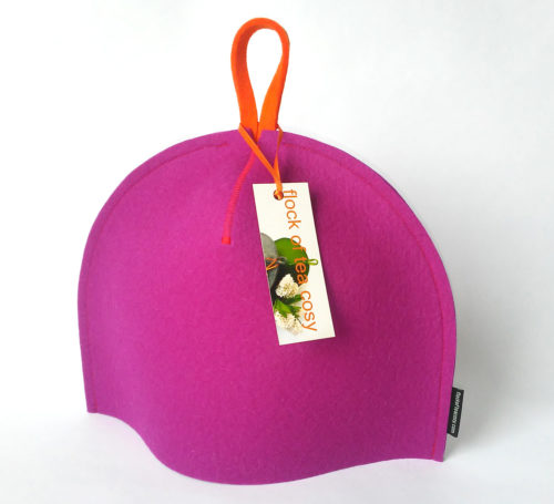 Small tea cosy in Magenta coloured thick wool felt with a fluorescent orange hang tab